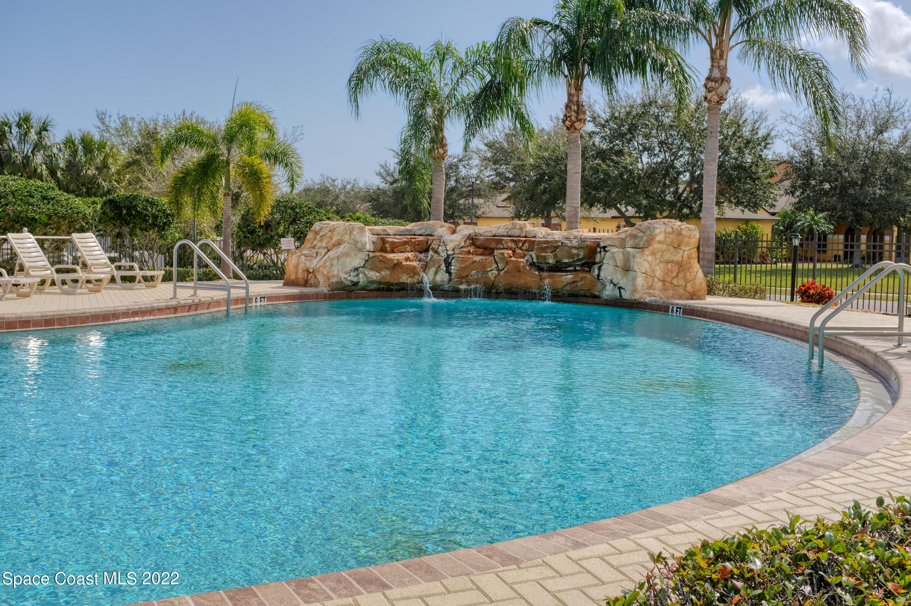 995 Luminary Circle, Unit 103 Melbourne, FL 32901 - Photo 25 of 27 a view of a swimming pool with a patio