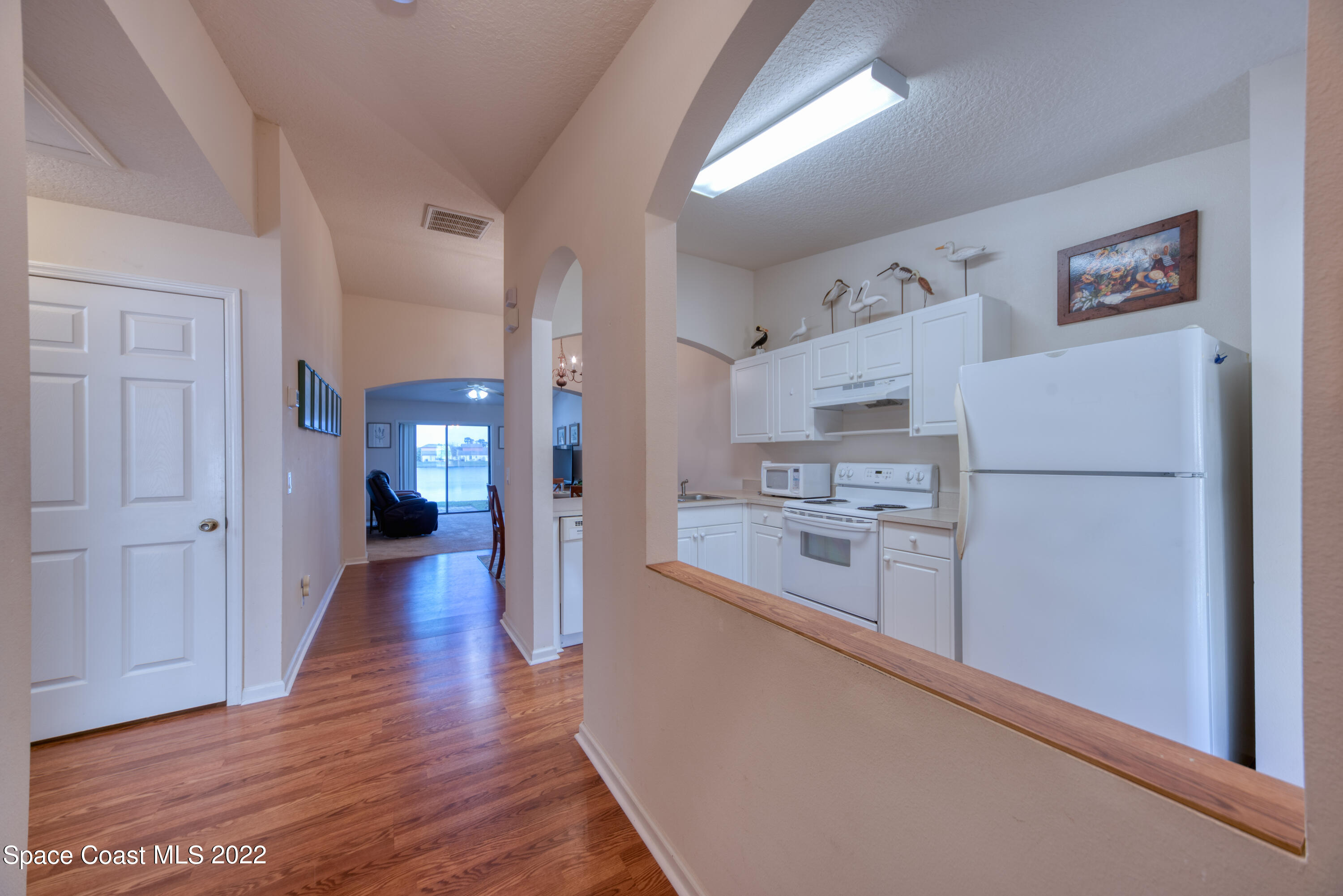 995 Luminary Circle, Unit 103 Melbourne, FL 32901 - Photo 6 of 27 a kitchen with white cabinets and stainless steel appliances