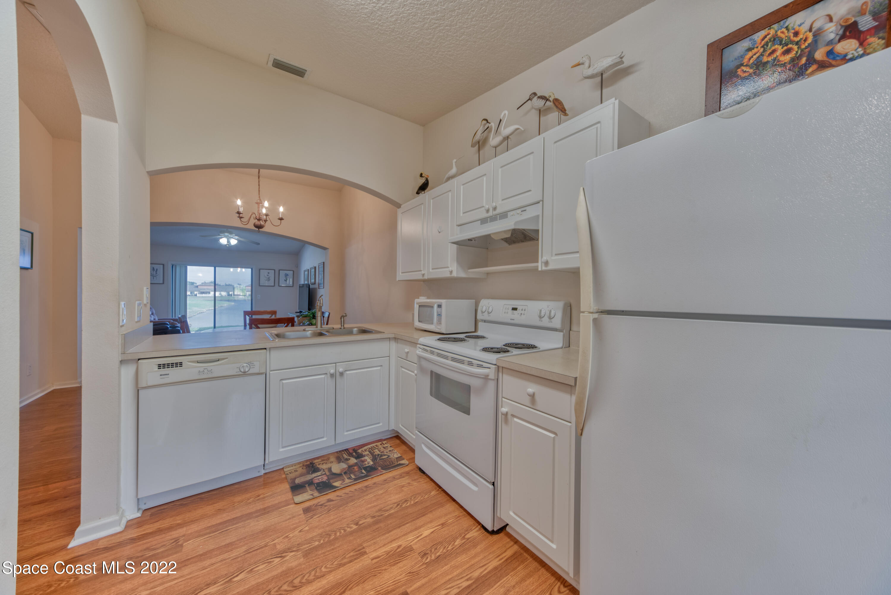 995 Luminary Circle, Unit 103 Melbourne, FL 32901 - Photo 7 of 27 a kitchen with white cabinets and white appliances