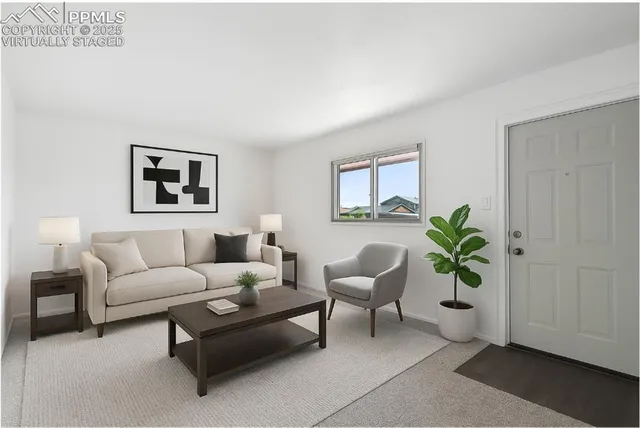 a living room with furniture and a potted plant