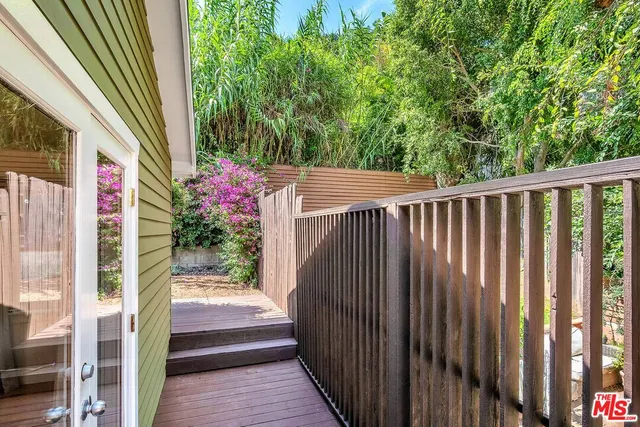 a view of a balcony with wooden floor