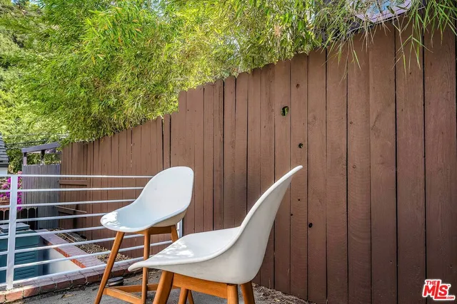 a view of a house with swimming pool and sitting area
