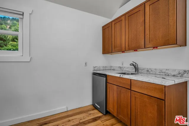 a bathroom with a granite countertop sink toilet and bathtub