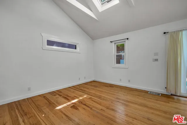 a view of a livingroom with wooden floor and a ceiling fan