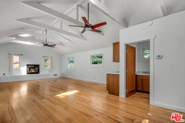 a view of empty room with wooden floor
