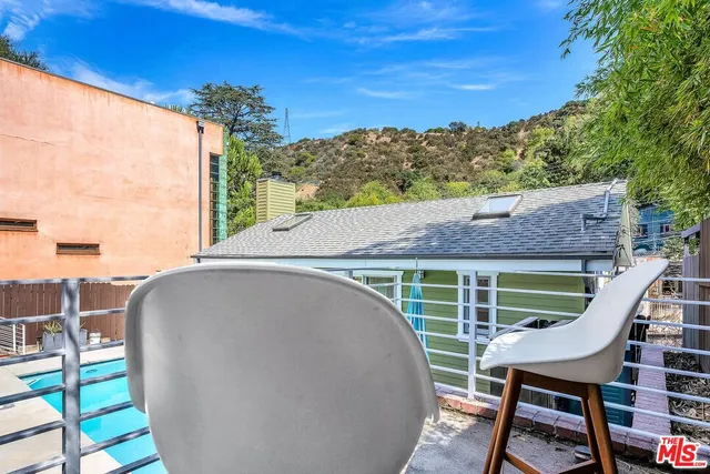 a view of an empty room with stairs and wooden floor