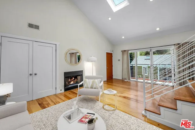 a living room with fireplace furniture and a fireplace