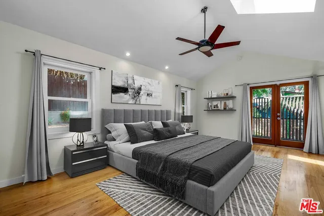 a bedroom with a large bed and a window