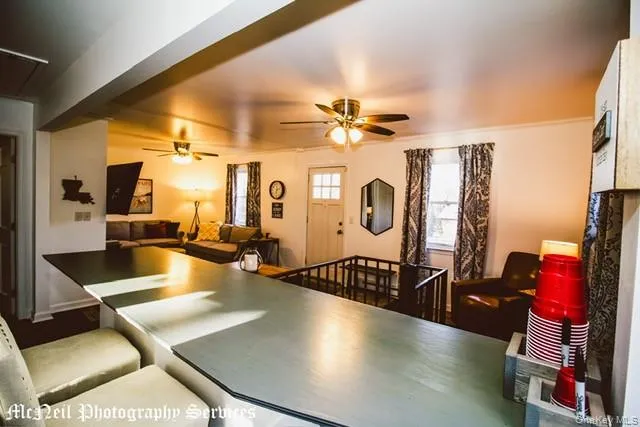 a view of a livingroom with furniture and a flat screen tv