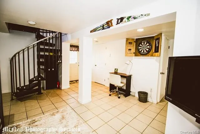 a view of a hallway with wooden floor and furniture