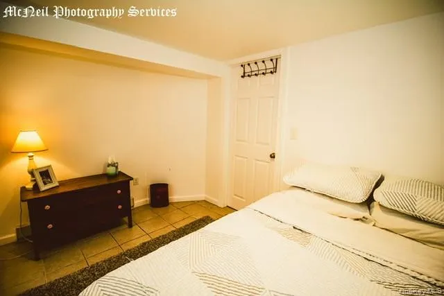 a bedroom with a bed and lamp