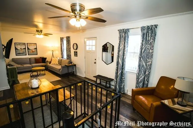 a view of a livingroom with furniture and a chandelier fan