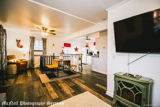 a living room with furniture fireplace and flat screen tv