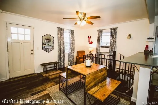 a view of a dining room with furniture and wooden floor