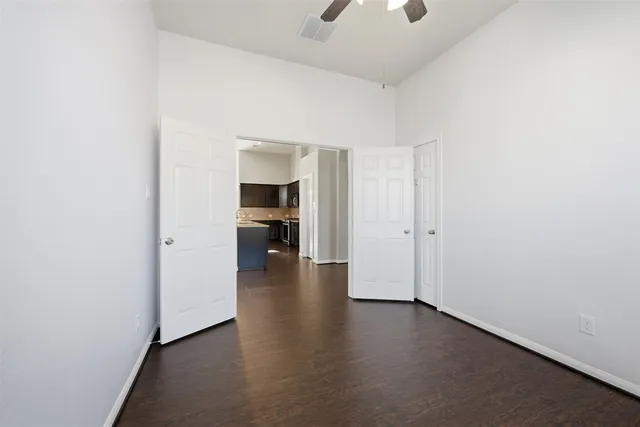 a view of empty room with wooden floor