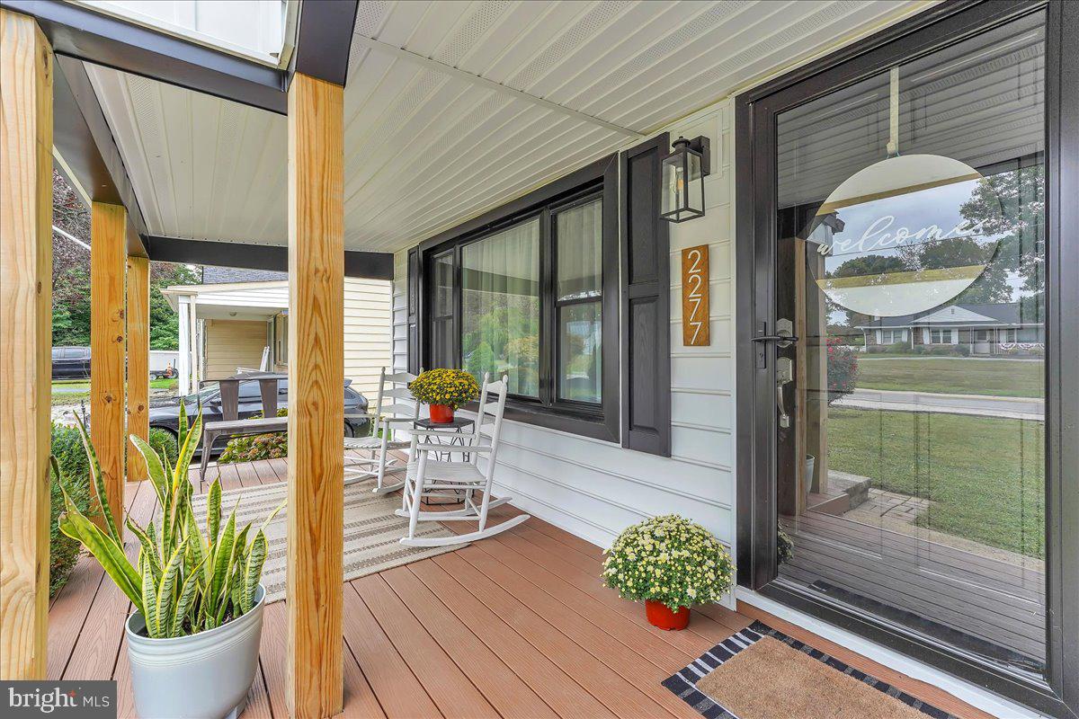 2277 Mill Road Upper Chichester, PA 19061 - Photo 21 of 30 a view of a porch with chairs and potted plants