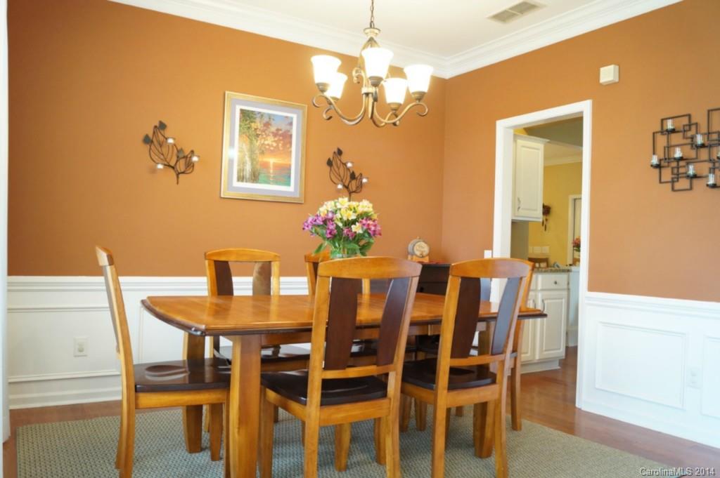 2224 Winthorp Ridge Road Charlotte, NC 28270 - Photo 2 of 24 a dining room with furniture a chandelier and wooden floor