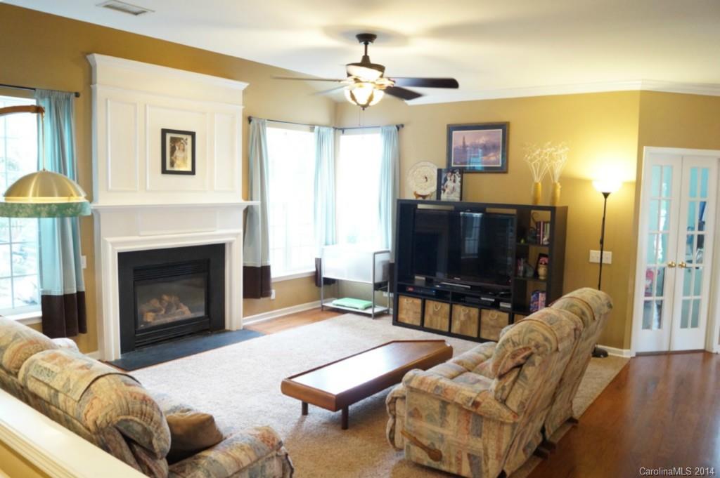 2224 Winthorp Ridge Road Charlotte, NC 28270 - Photo 9 of 24 a living room with furniture a fireplace and a flat screen tv