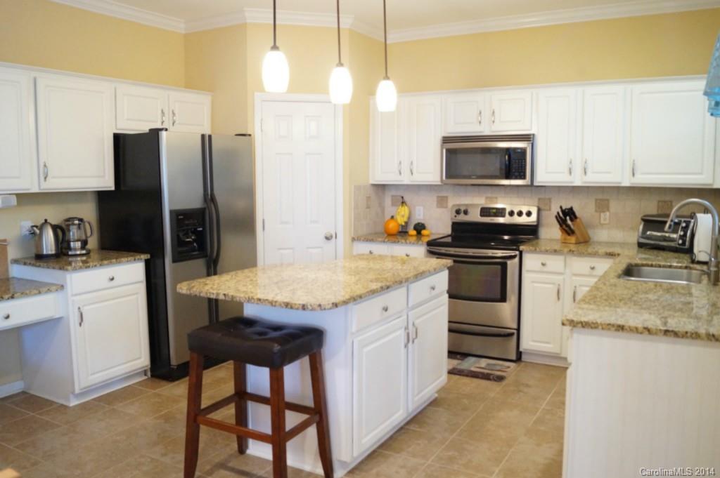 2224 Winthorp Ridge Road Charlotte, NC 28270 - Photo 10 of 24 a kitchen with stainless steel appliances granite countertop a stove a refrigerator a sink a microwave and island