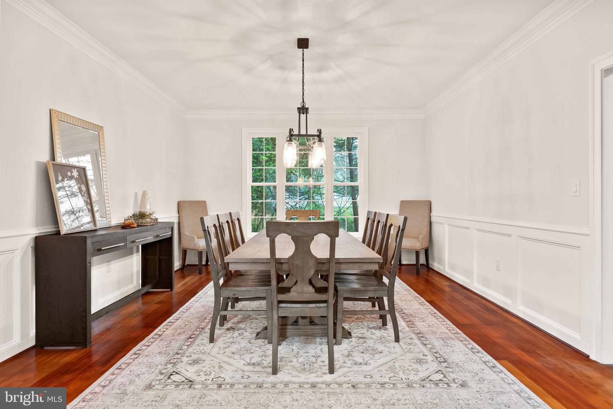 8522 Lewinsville Road McLean, VA 22102 - Photo 11 of 51 a dining room with furniture a chandelier and wooden floor