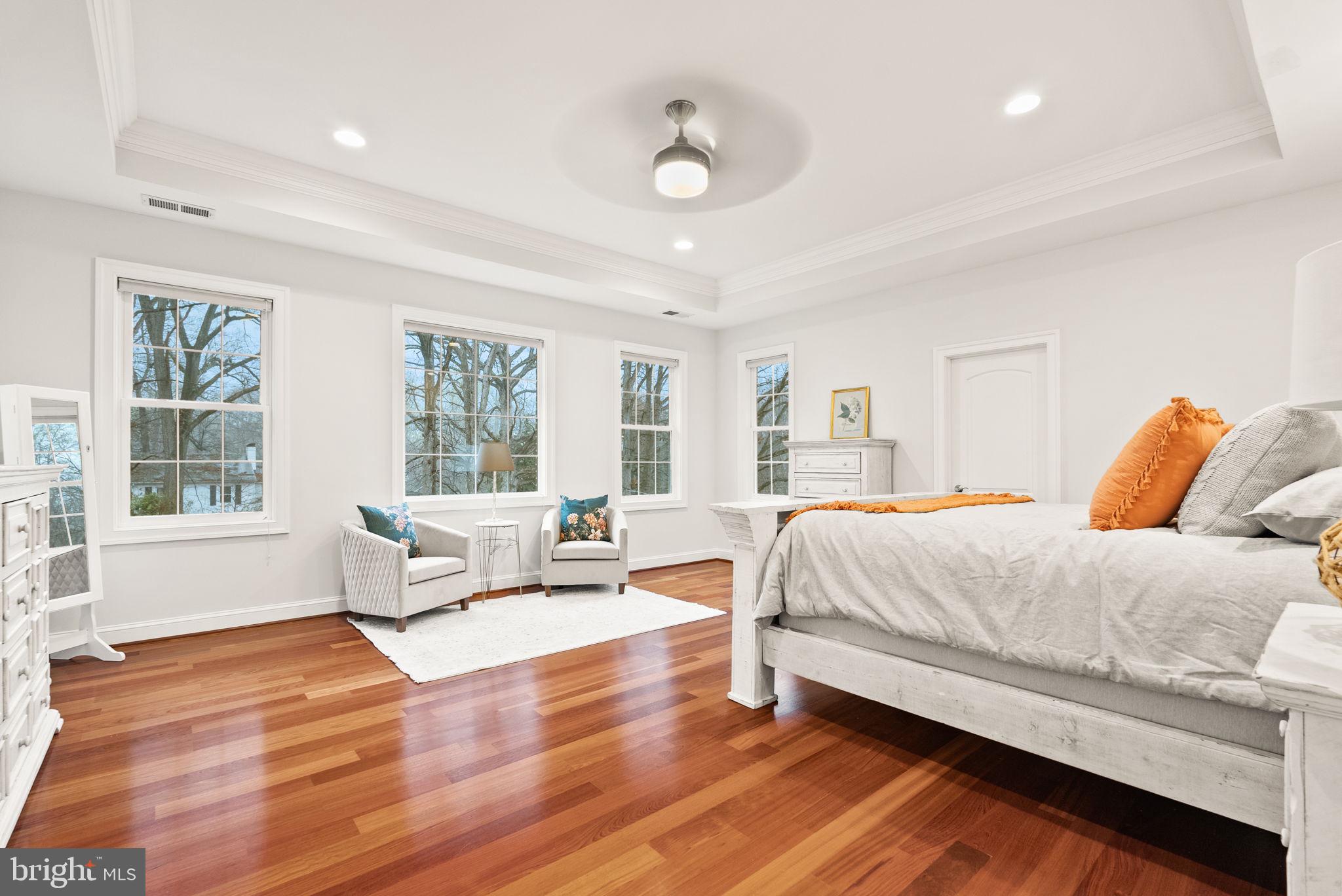 8522 Lewinsville Road McLean, VA 22102 - Photo 16 of 51 a spacious bedroom with a bed and wooden floor