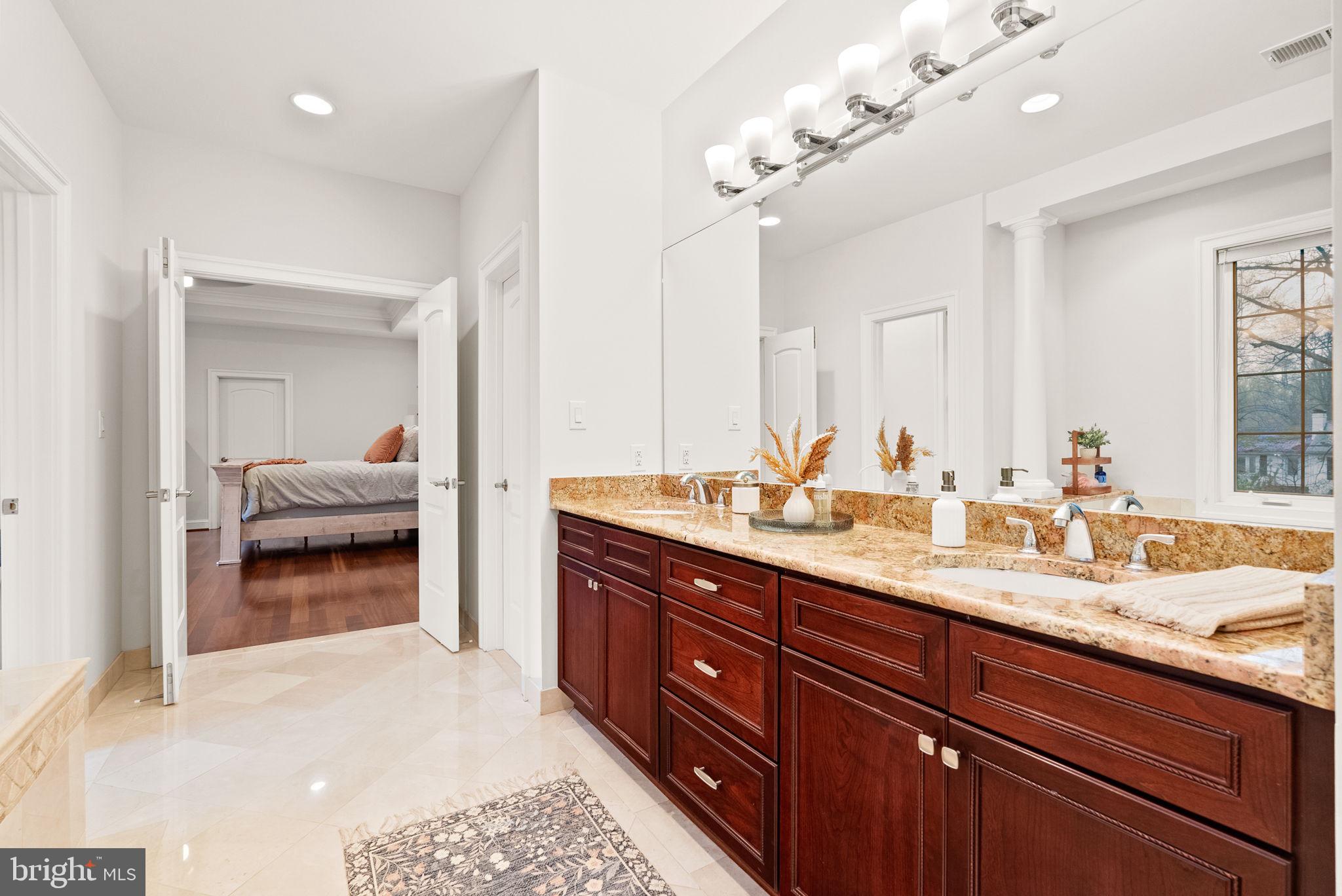 8522 Lewinsville Road McLean, VA 22102 - Photo 21 of 51 a en suite bathroom with double vanity and a mirror