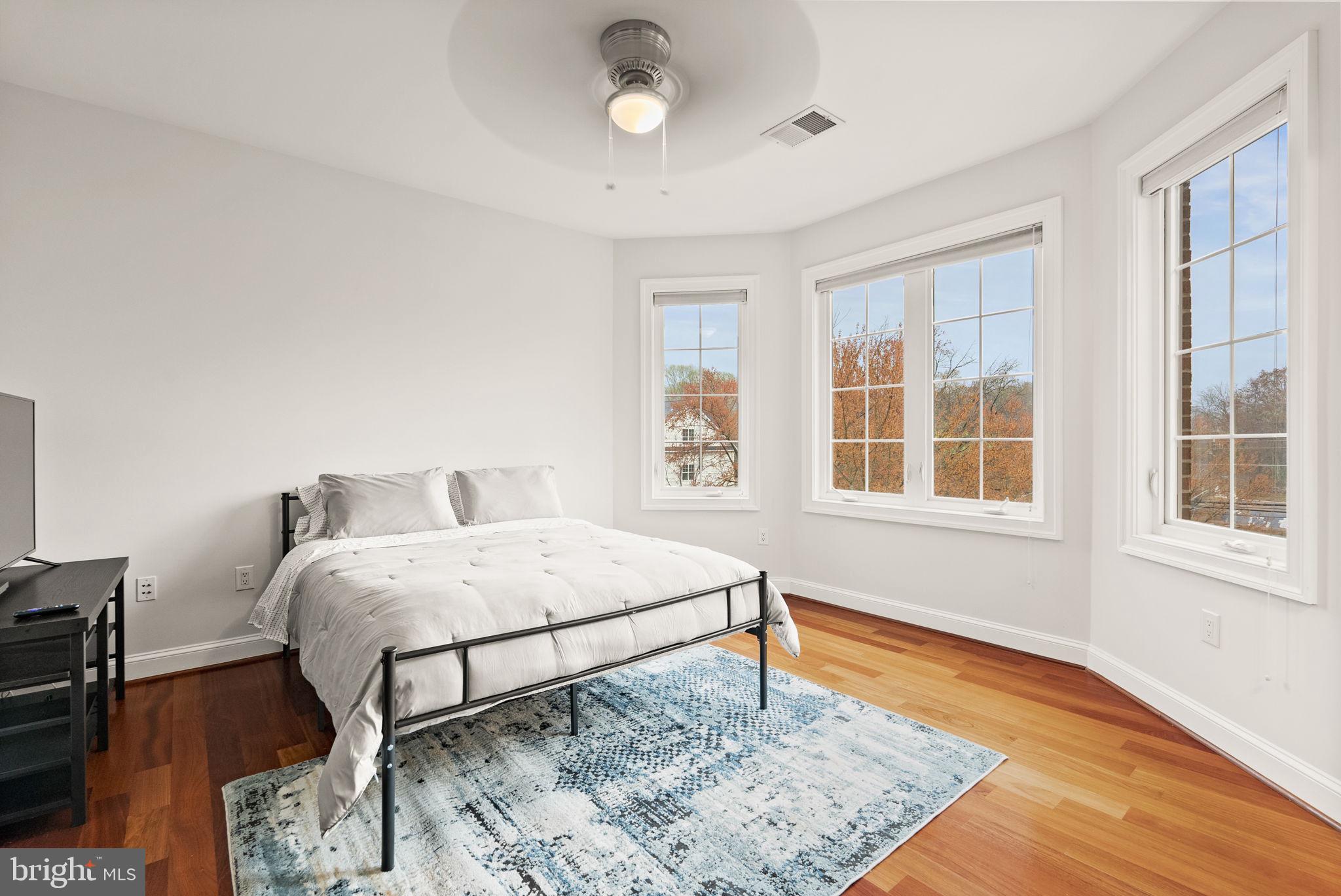 8522 Lewinsville Road McLean, VA 22102 - Photo 36 of 51 a bedroom with a bed and wooden floor