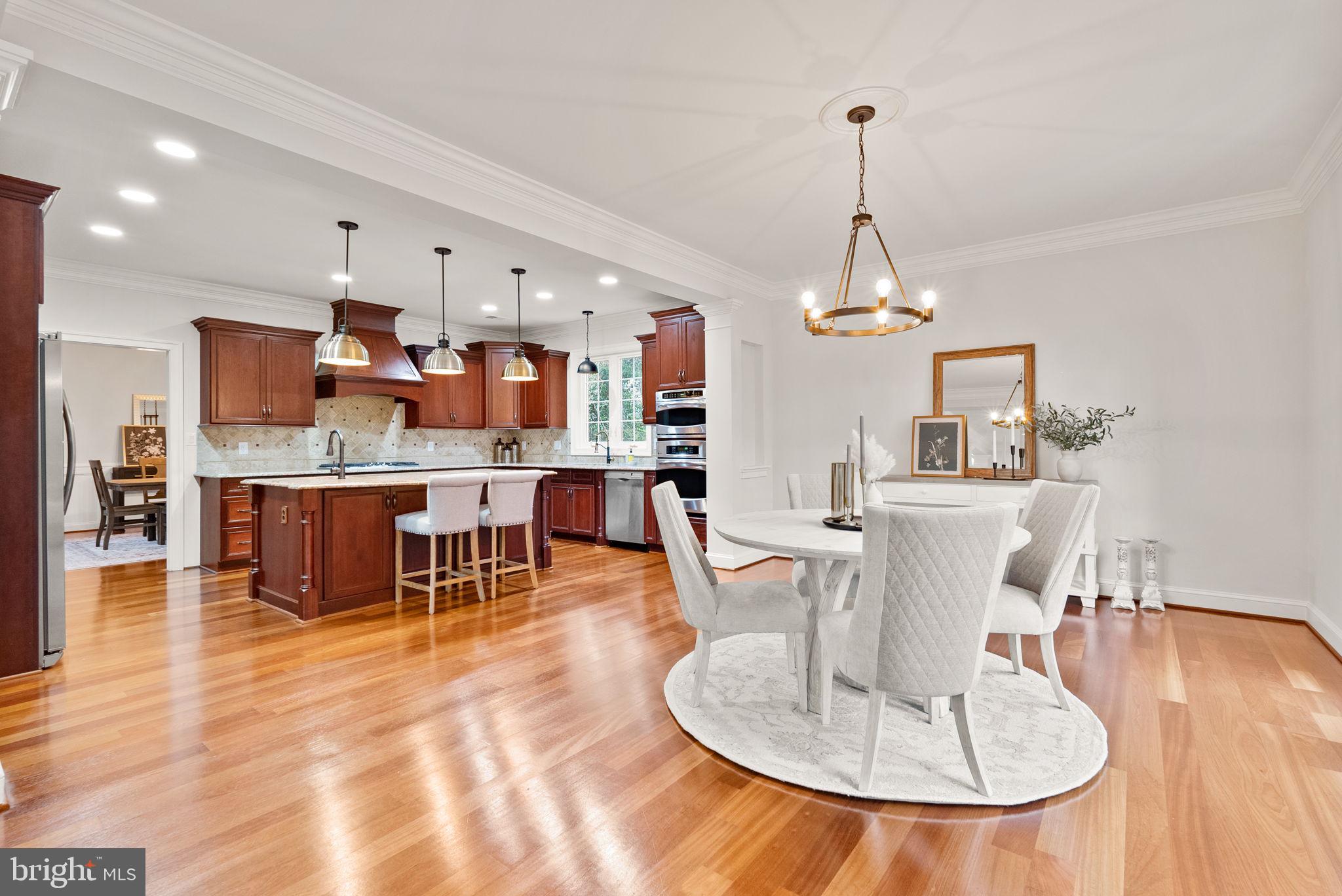 8522 Lewinsville Road McLean, VA 22102 - Photo 4 of 51 a dining room with wooden floor a glass table and chairs