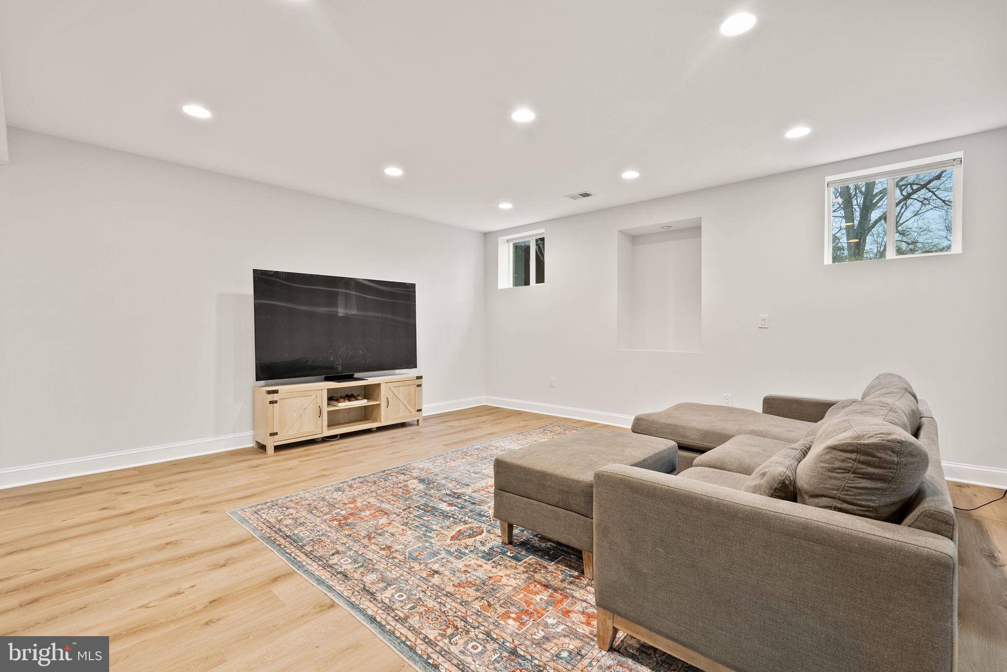 8522 Lewinsville Road McLean, VA 22102 - Photo 41 of 51 a living room with furniture and a flat screen tv