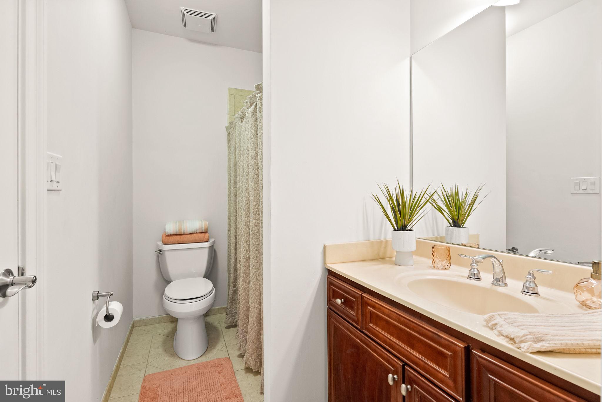 8522 Lewinsville Road McLean, VA 22102 - Photo 45 of 51 a bathroom with a granite countertop sink a toilet and a mirror