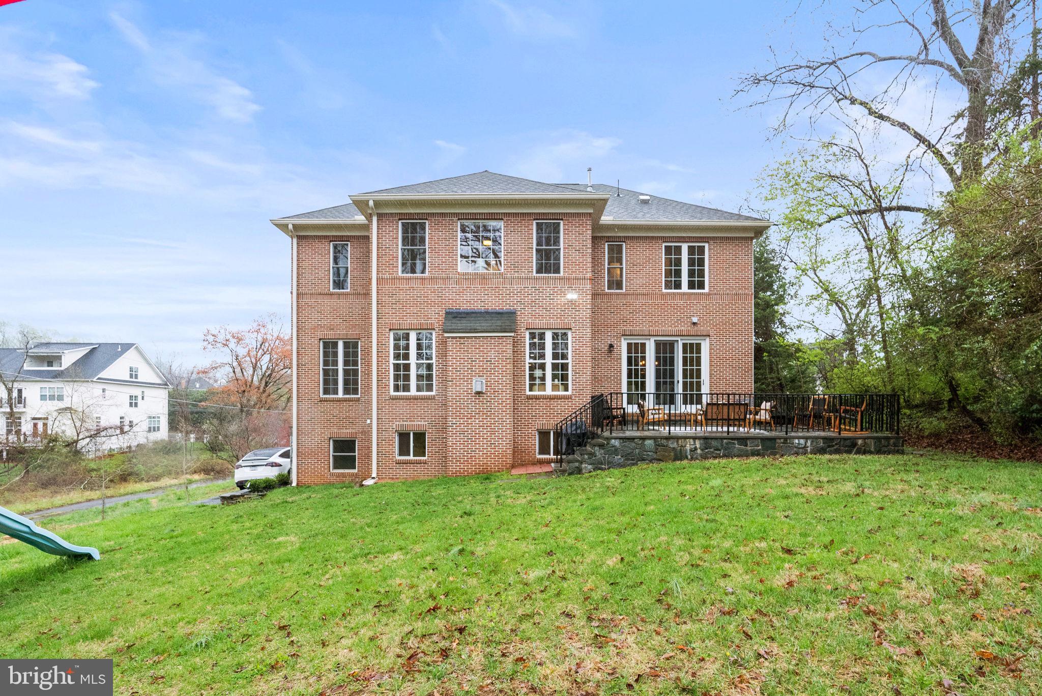 8522 Lewinsville Road McLean, VA 22102 - Photo 50 of 51 a front view of a house with a yard and trees