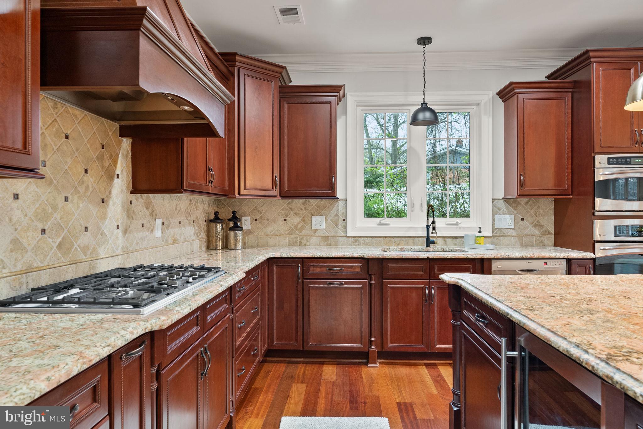 8522 Lewinsville Road McLean, VA 22102 - Photo 7 of 51 a kitchen with stainless steel appliances granite countertop a stove a sink dishwasher and microwave oven with cabinets