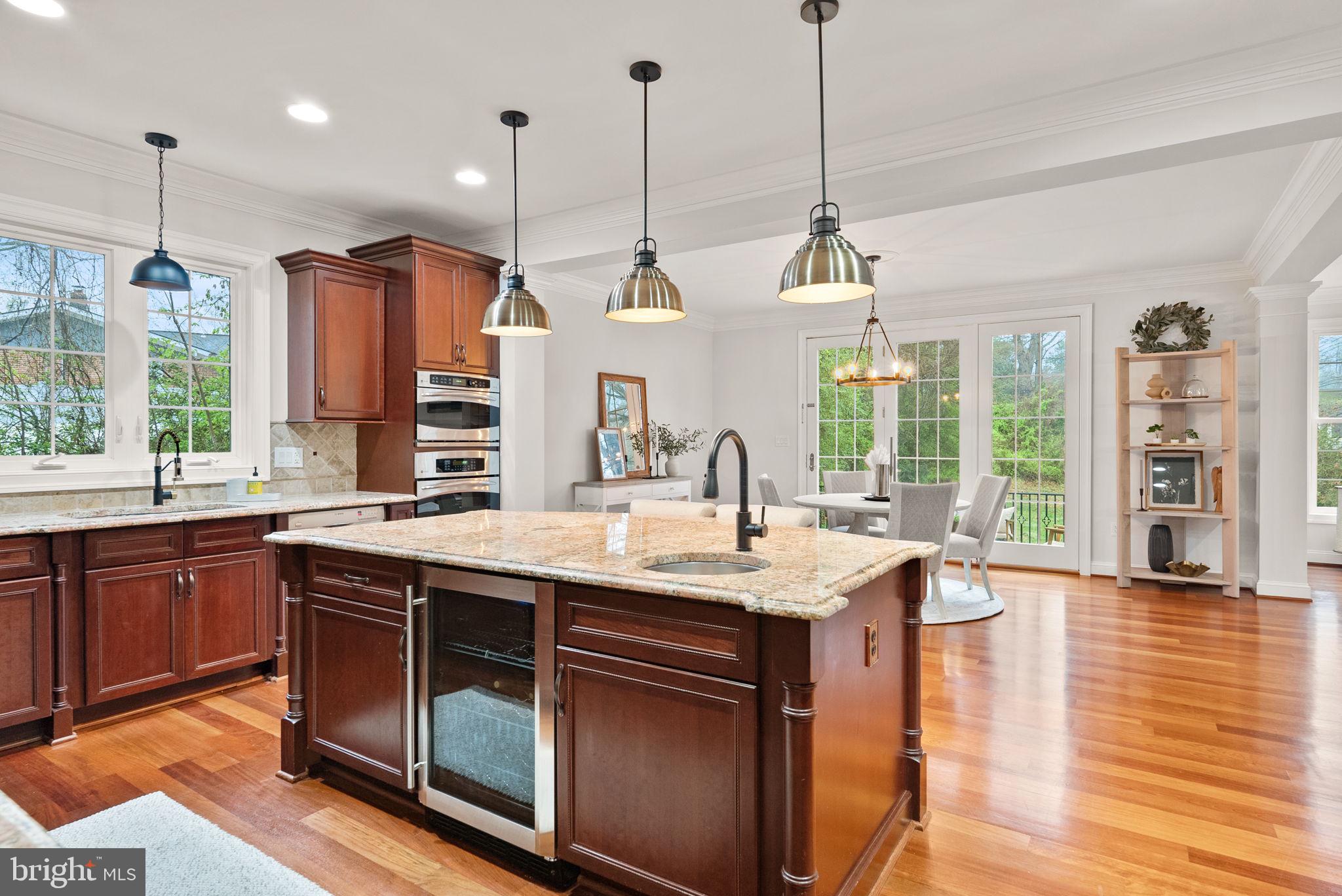 8522 Lewinsville Road McLean, VA 22102 - Photo 8 of 51 a kitchen with stainless steel appliances granite countertop a sink a stove and a wooden floor