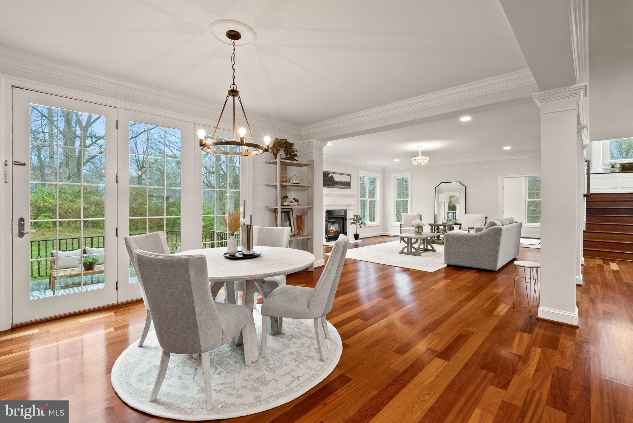 8522 Lewinsville Road McLean, VA 22102 - Photo 10 of 51 a dining room with wooden floor a chandelier a glass table and chairs