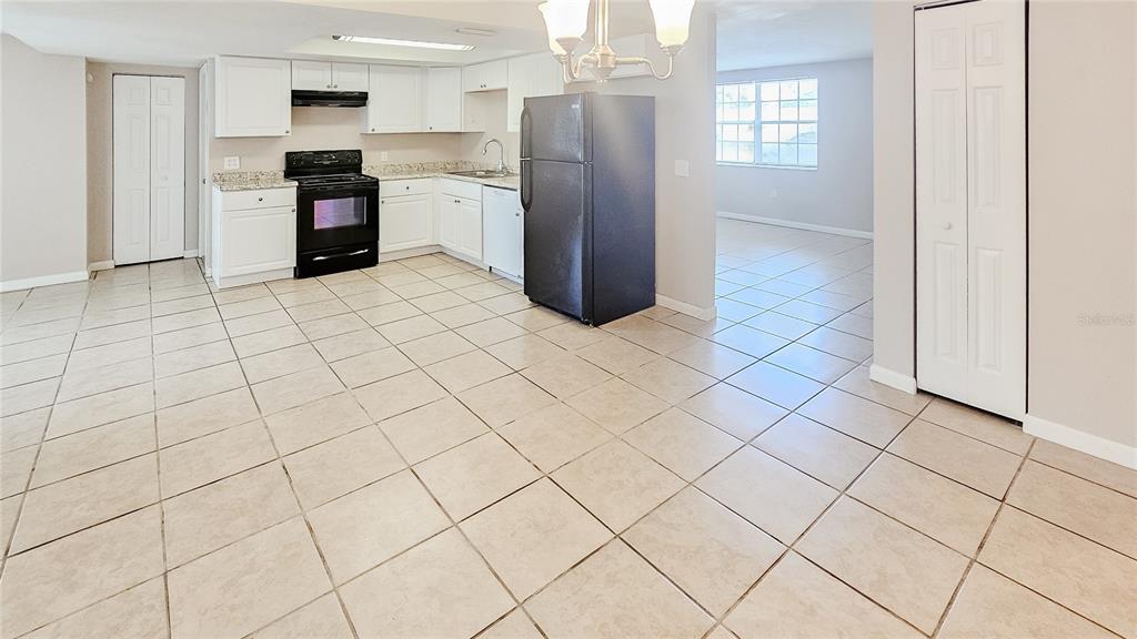 7304 Embassy Boulevard Port Richey, FL 34668 - Photo 8 of 14 a kitchen with stainless steel appliances granite countertop a refrigerator and a sink