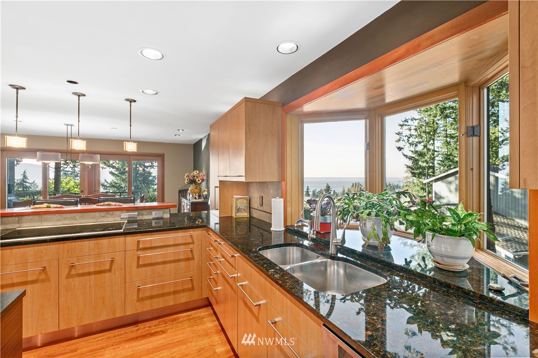 629 Fieldston Road Bellingham, WA 98225 - Photo 6 of 25 a large kitchen with kitchen island granite countertop a large window and cabinets