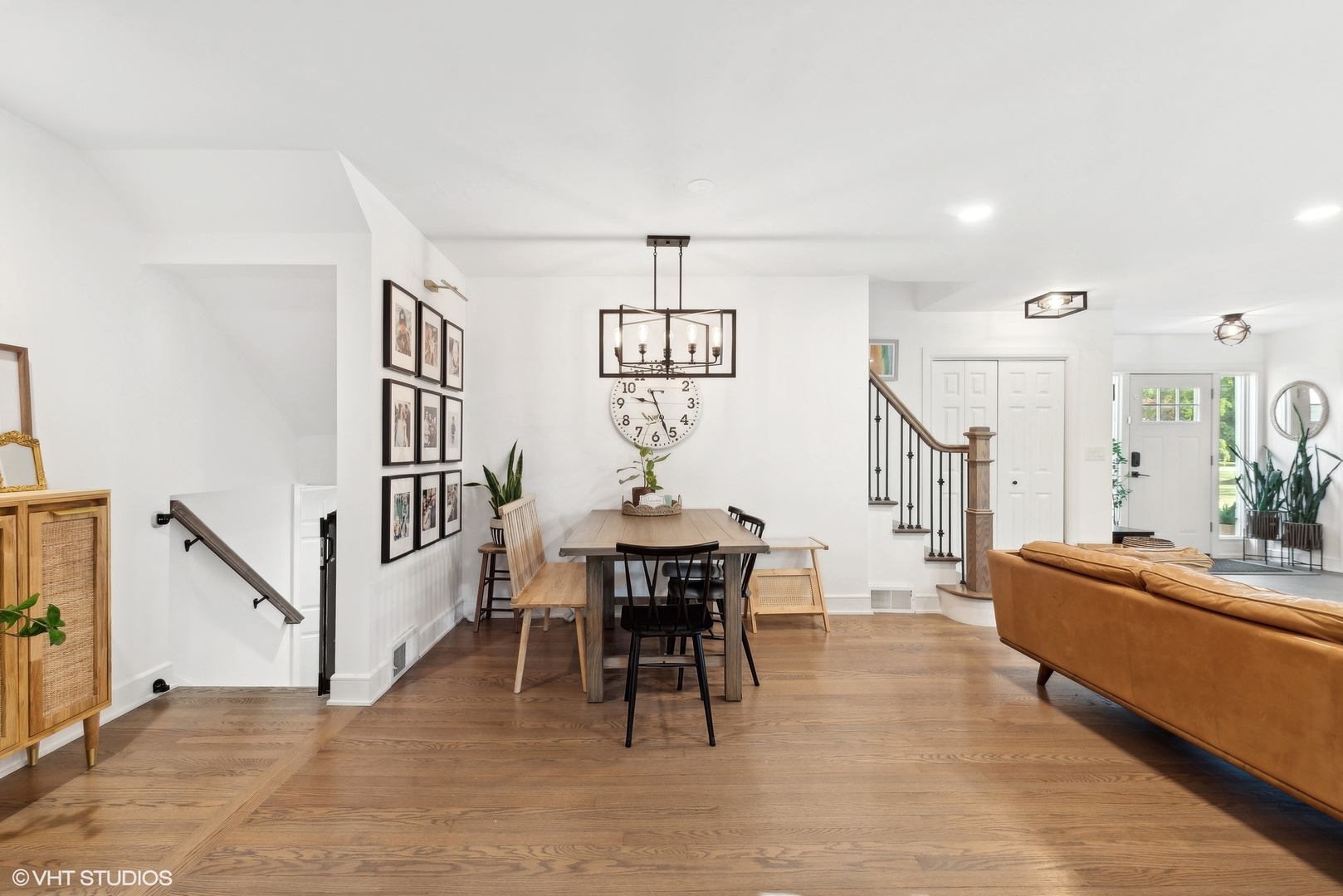 205 West Willow Road Prospect Heights, IL 60070 - Photo 7 of 30 a living room with furniture a dining table and a chandelier