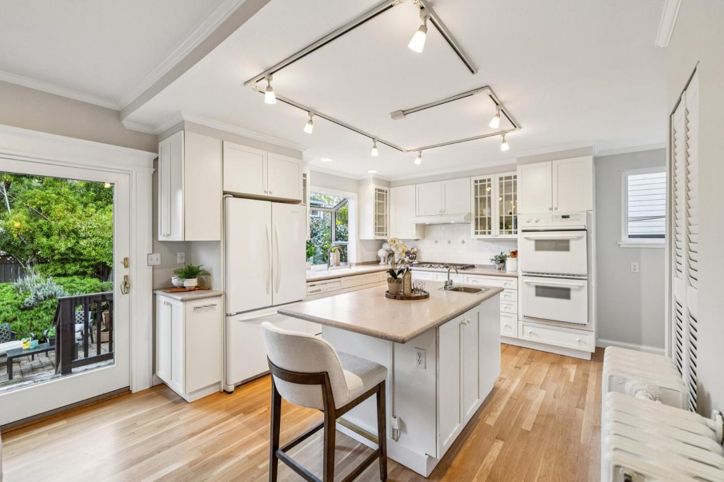 712 Crossway Road Burlingame, CA 94010 - Photo 35 of 90 a kitchen with refrigerator cabinets and wooden floor