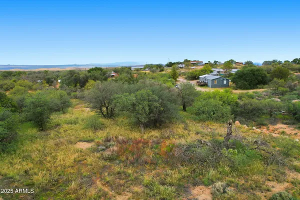 an aerial view of residential houses with outdoor space and trees