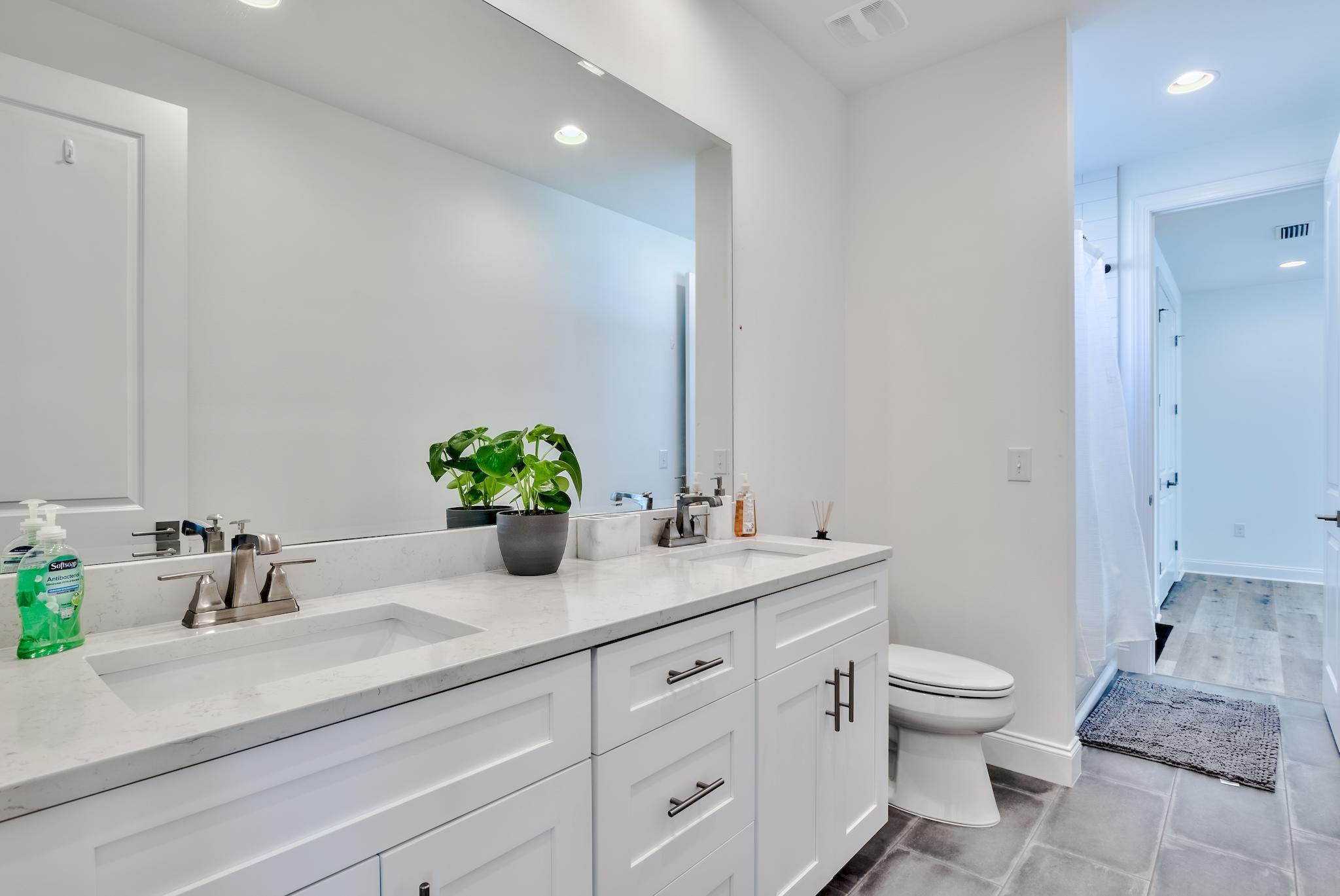 25 Cambium Court Watersound, FL 32461 - Photo 12 of 23 a bathroom with a sink a toilet and a large mirror