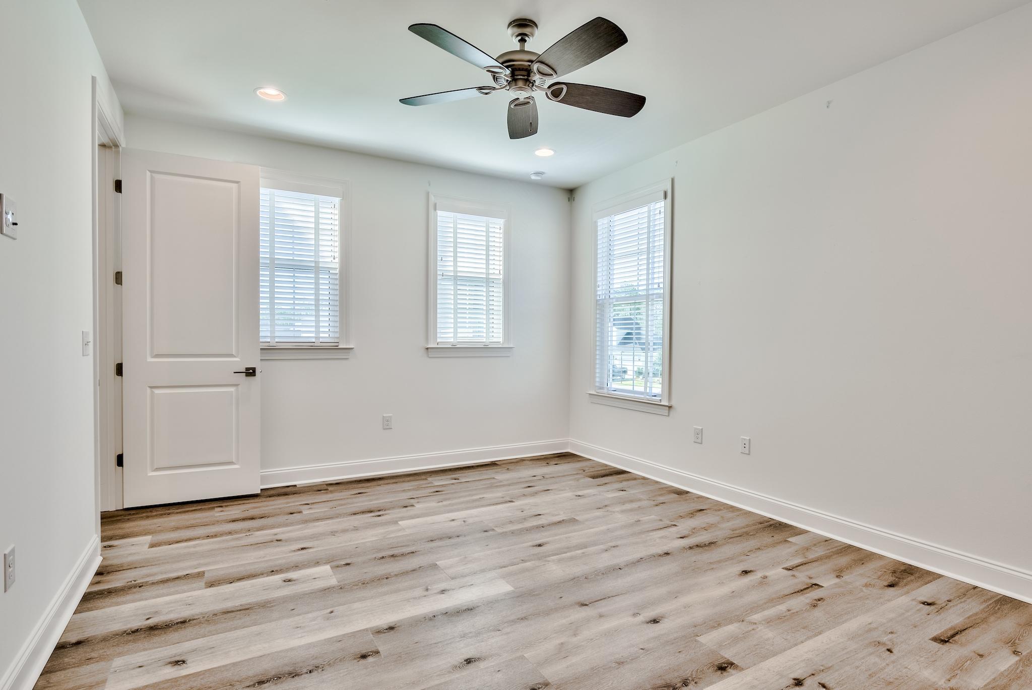 25 Cambium Court Watersound, FL 32461 - Photo 18 of 23 a view of an empty room with window and wooden floor