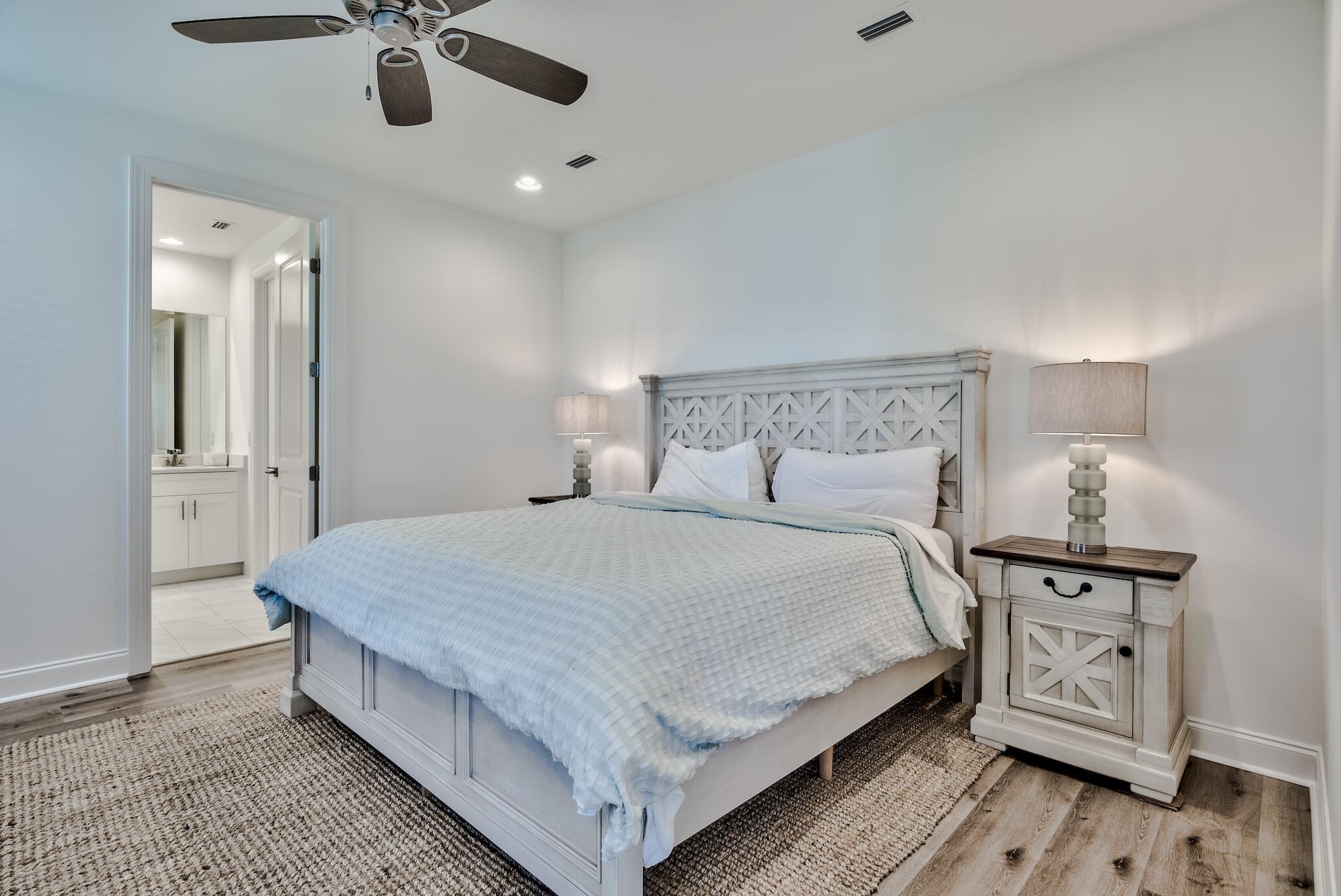 25 Cambium Court Watersound, FL 32461 - Photo 7 of 23 a bedroom with a bed and painting on the wall