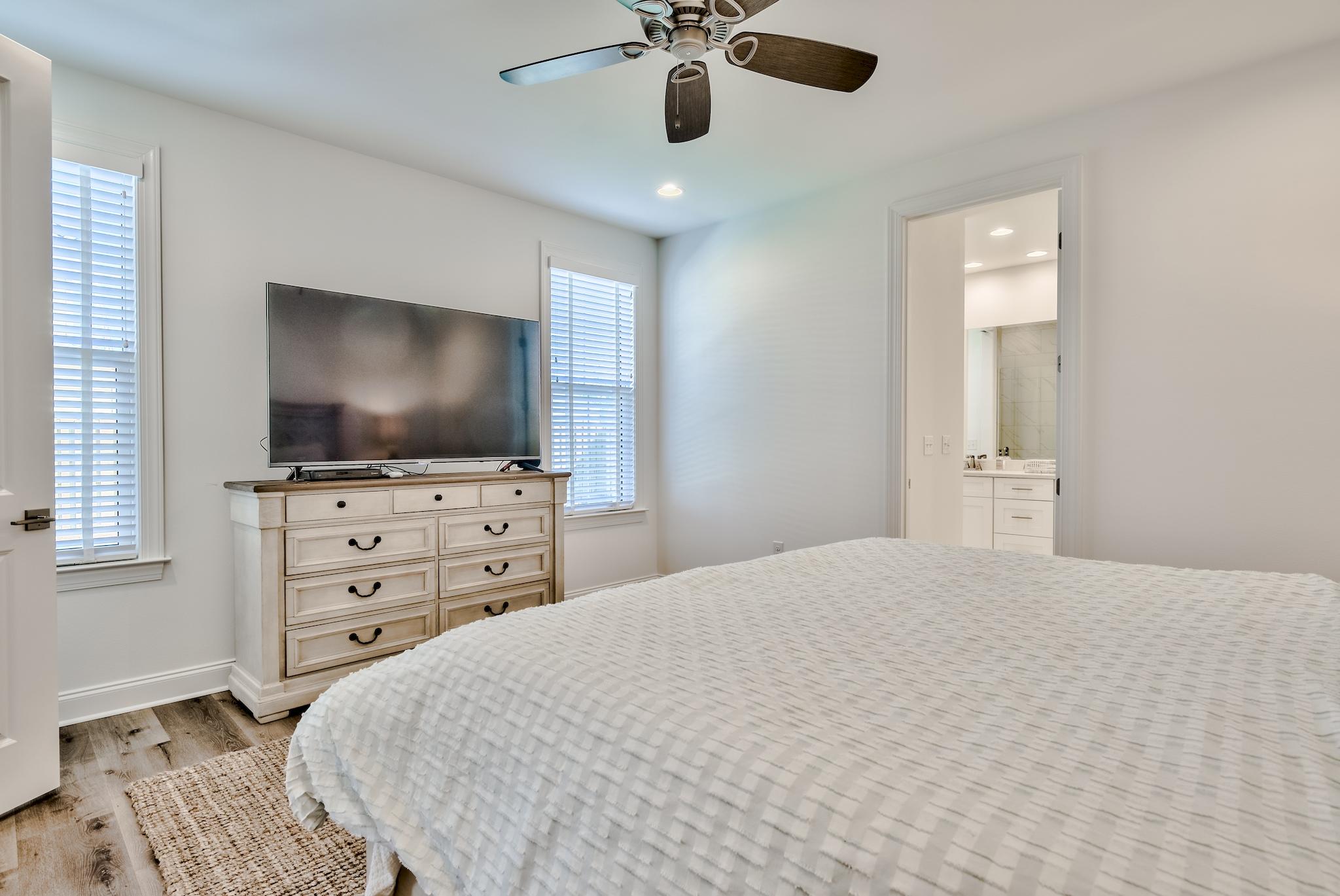 25 Cambium Court Watersound, FL 32461 - Photo 8 of 23 a bedroom with a bed and a flat screen tv