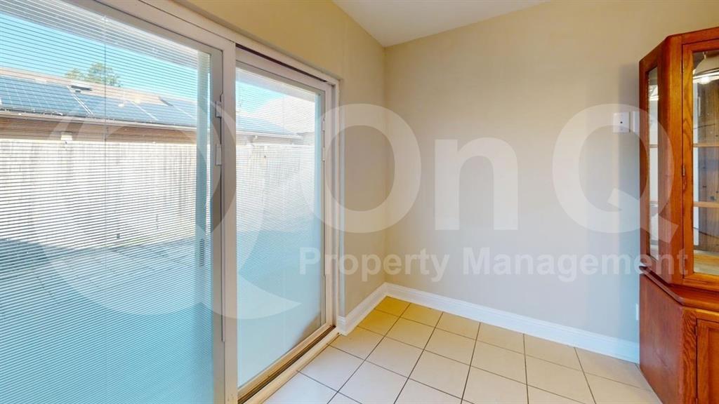 3005 Meandering Way Bedford, TX 76021 - Photo 4 of 24 Sliding glass door opening to an outdoor area with a privacy fence