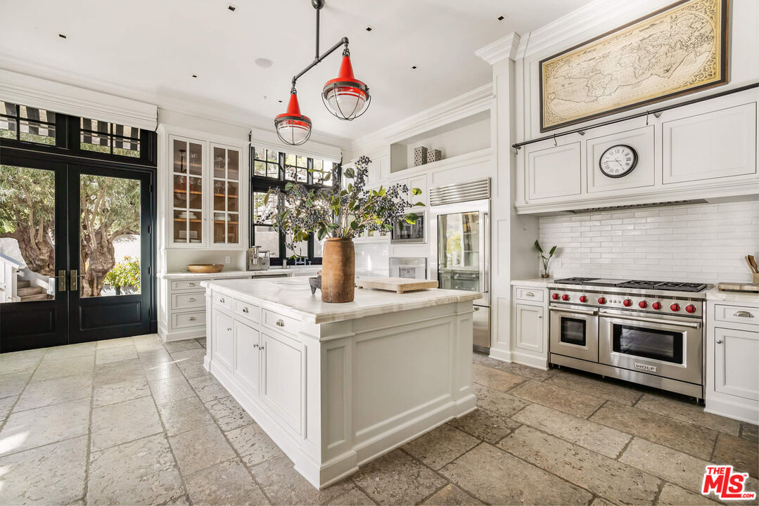 9779 Oak Pass Road Beverly Hills, CA 90210 - Photo 11 of 43 a kitchen with stainless steel appliances granite countertop a stove and cabinets