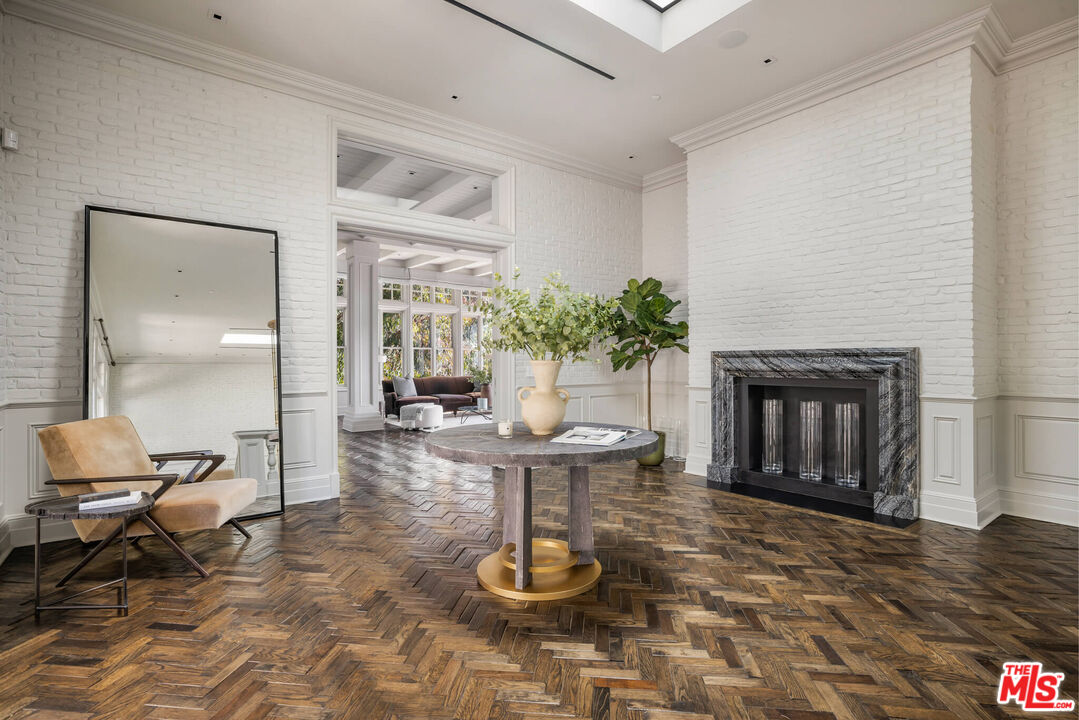 9779 Oak Pass Road Beverly Hills, CA 90210 - Photo 16 of 43 a living room with furniture and a fireplace