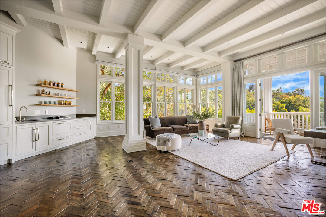 9779 Oak Pass Road Beverly Hills, CA 90210 - Photo 17 of 43 a living room with furniture and large windows