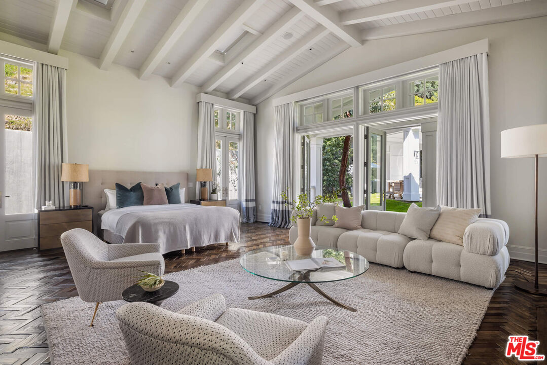 9779 Oak Pass Road Beverly Hills, CA 90210 - Photo 18 of 43 a spacious bedroom with furniture and a large window
