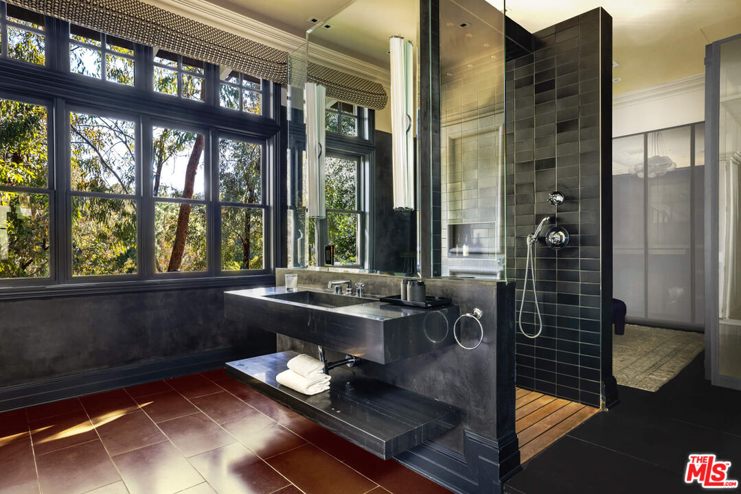 9779 Oak Pass Road Beverly Hills, CA 90210 - Photo 21 of 43 a room with gym equipment and a large window