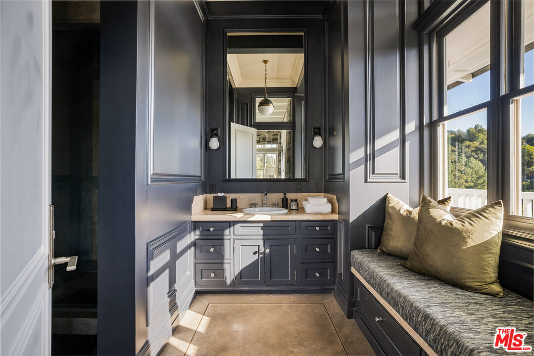 9779 Oak Pass Road Beverly Hills, CA 90210 - Photo 25 of 43 a living room with furniture and a window